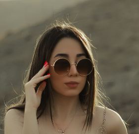 a girl with glasses in the mountains